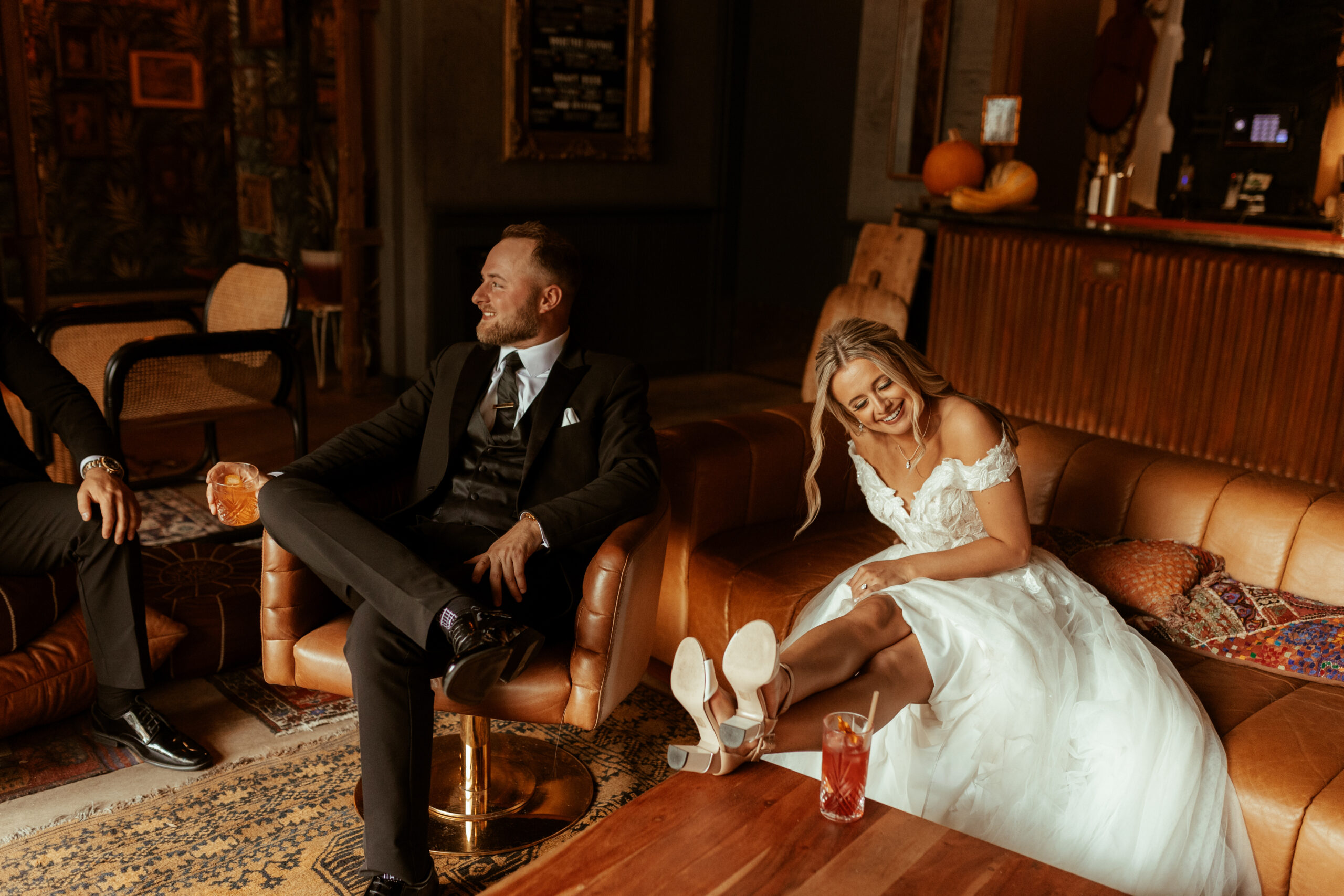 married couple sitting in wedding attire at somerset bar during fall cincinnati wedding
