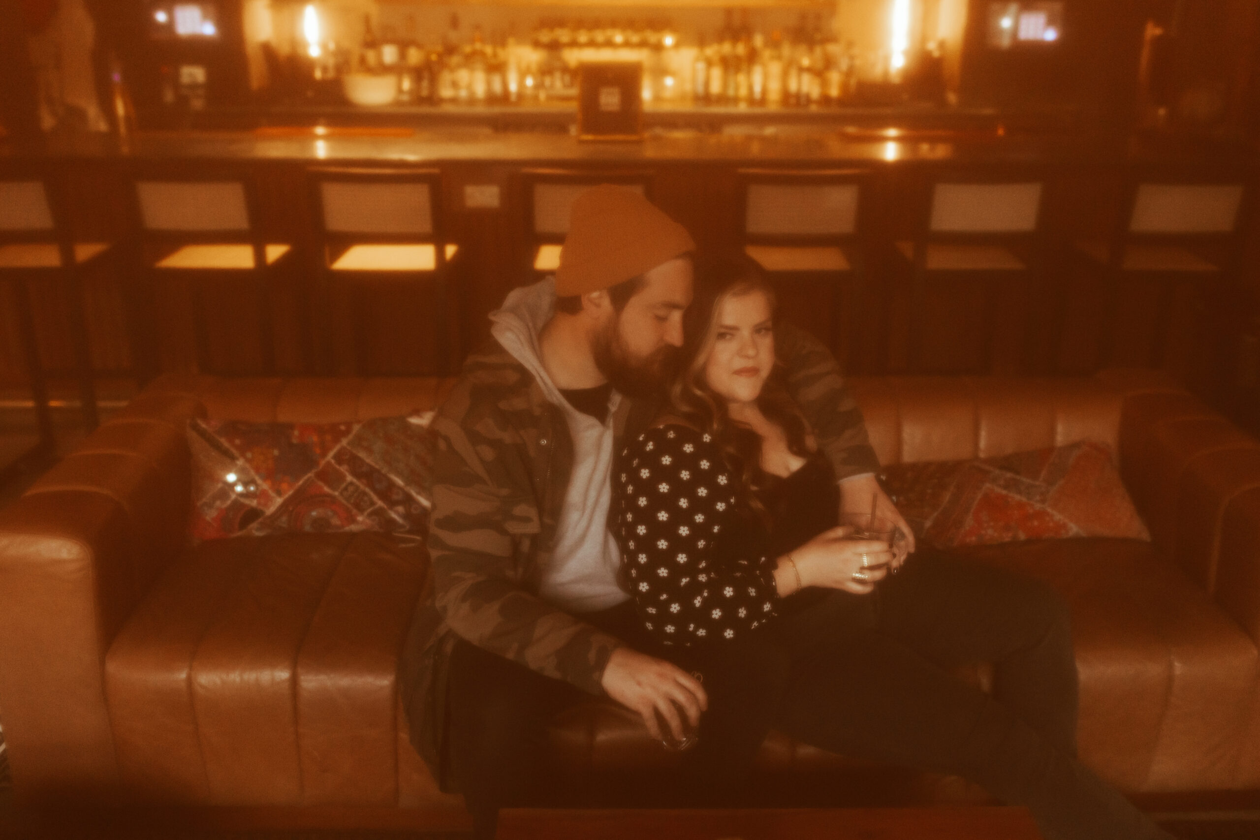 couple sitting at somerset bar having a drink for downtown engagement photos