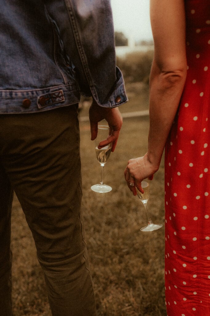 couple holding champagne glasses together