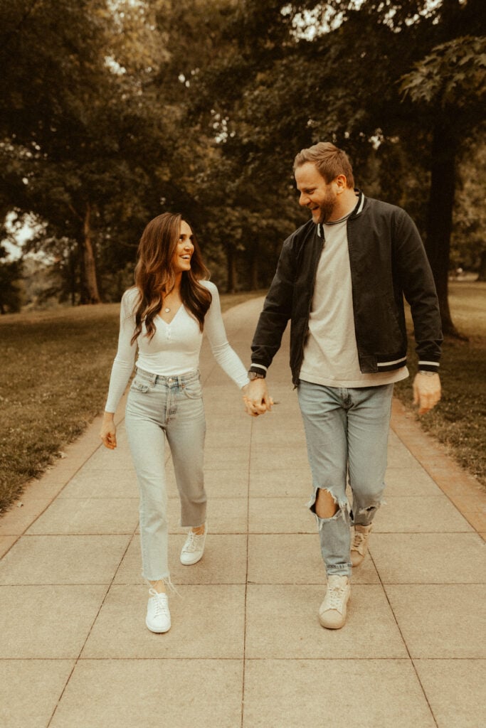 couple walking hand in hand for candid engagement photos