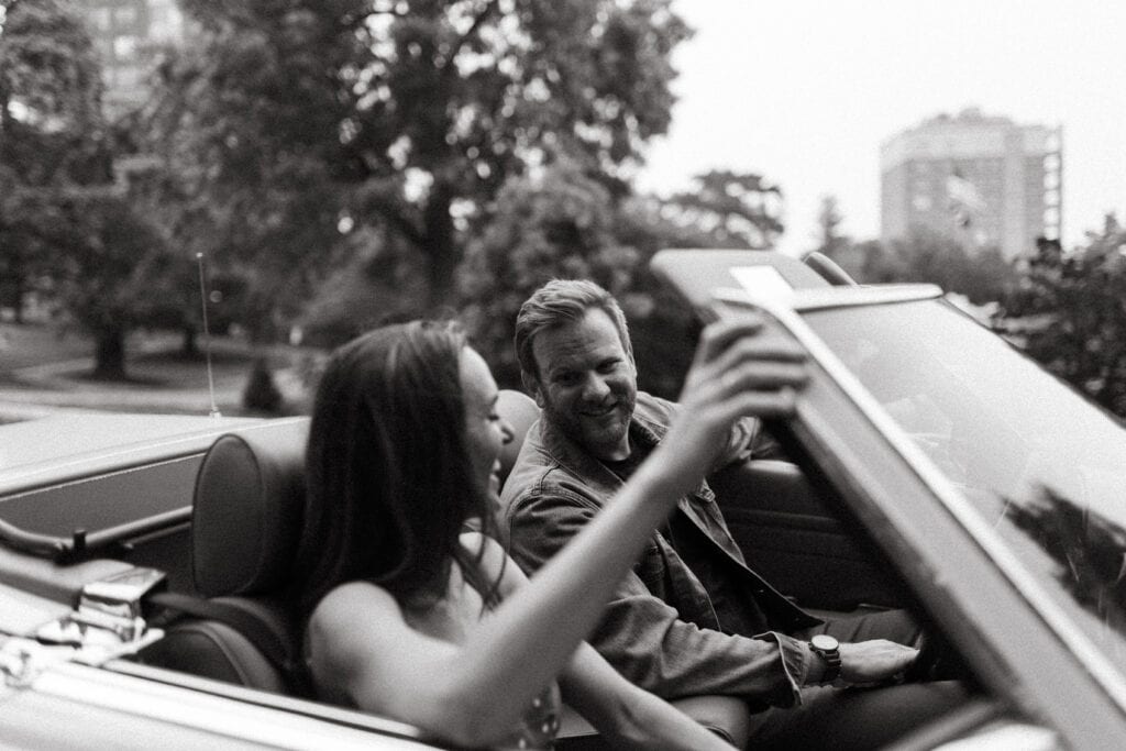 couple riding around in vintage car for retro engagement photos